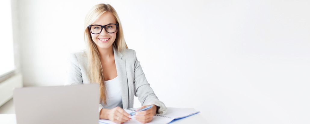 business and education concept - indoor picture of smiling woman with documents and pen